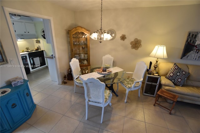 tiled dining area featuring a chandelier