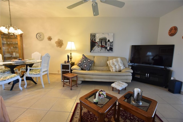 living room featuring light tile patterned flooring and ceiling fan with notable chandelier