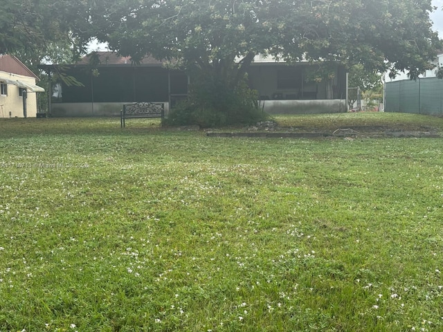 view of yard featuring a sunroom