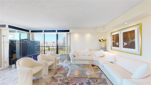 living room featuring a textured ceiling and a wall of windows