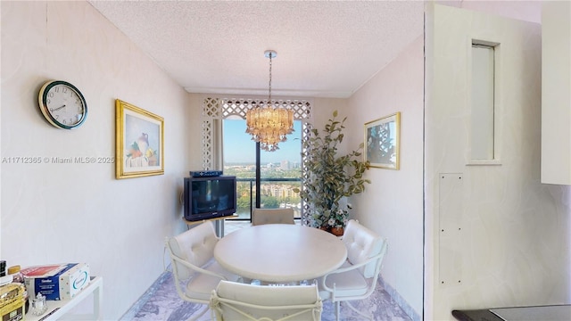 dining room featuring a textured ceiling and a chandelier