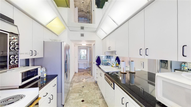 kitchen with stove and white cabinets