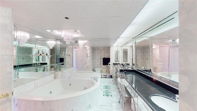 bathroom featuring vanity and tiled tub