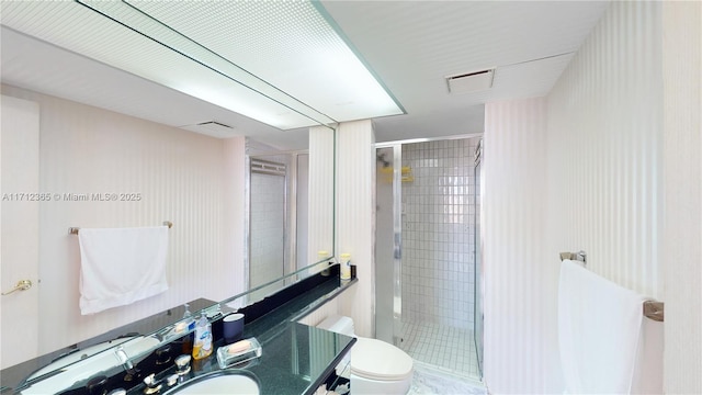 bathroom with toilet and an enclosed shower