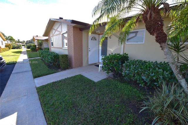 view of exterior entry with a lawn