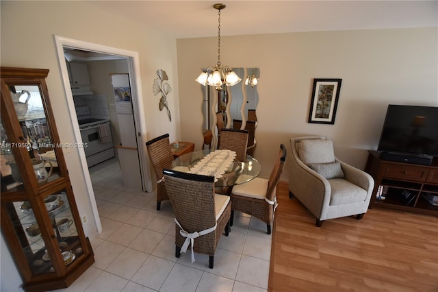 tiled dining area with an inviting chandelier