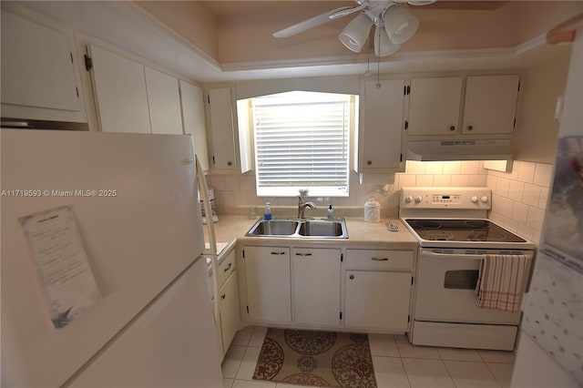 kitchen with white cabinetry, white fridge, sink, and electric stove