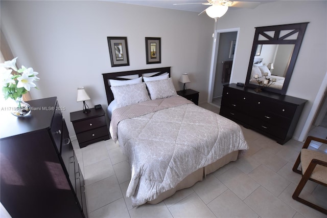 tiled bedroom featuring ceiling fan