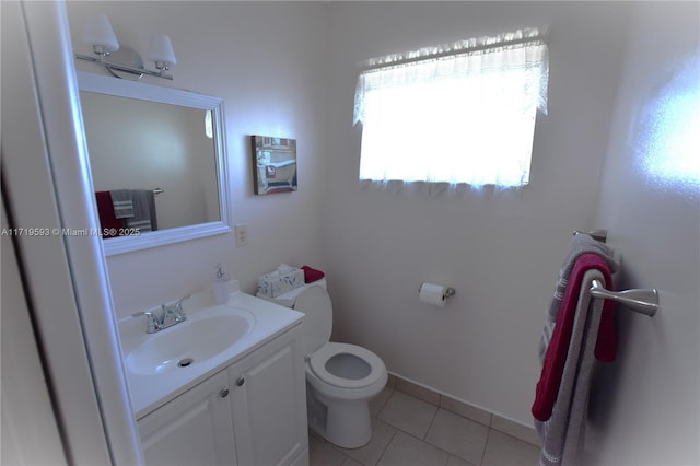 bathroom with tile patterned flooring, vanity, and toilet