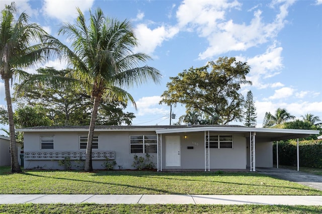 ranch-style house featuring a carport and a front yard