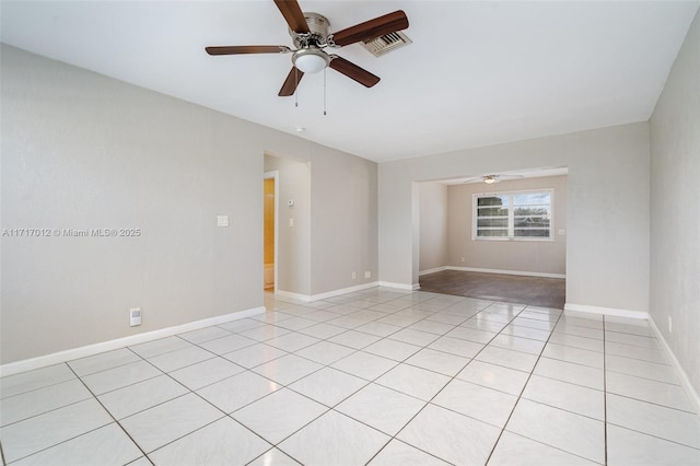 empty room with ceiling fan and light tile patterned flooring