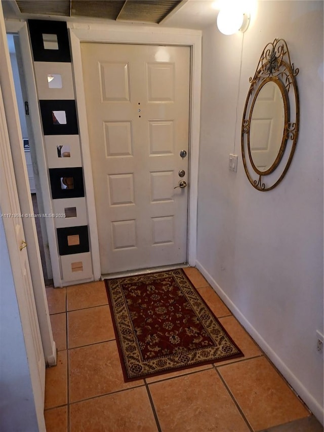 doorway with light tile patterned floors