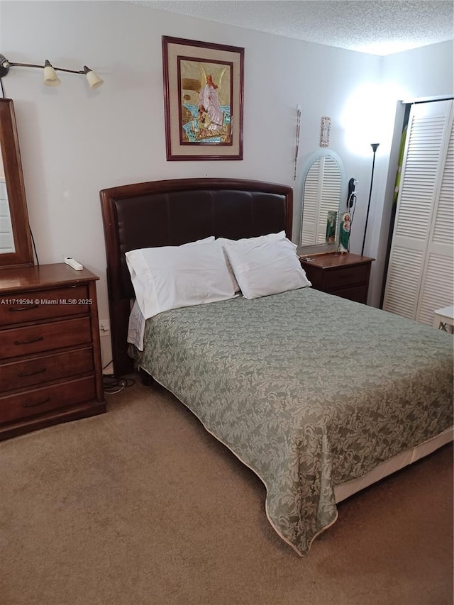 carpeted bedroom featuring a textured ceiling