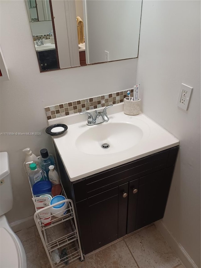 bathroom with backsplash, tile patterned floors, vanity, and toilet