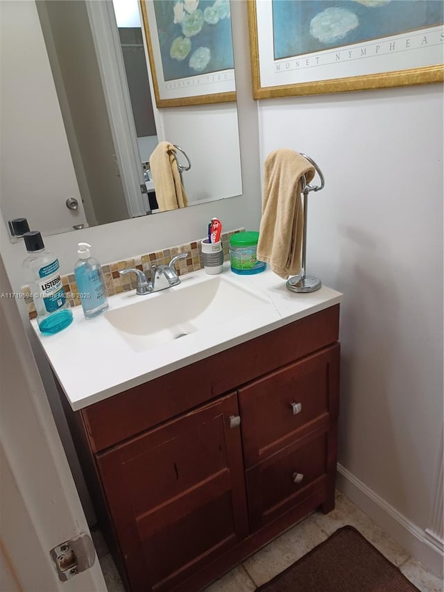 bathroom featuring vanity and backsplash