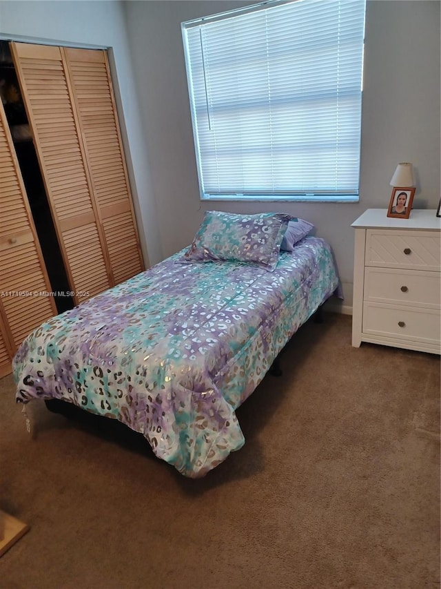 carpeted bedroom with a closet