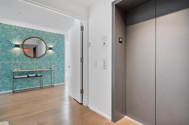 hall featuring elevator and light wood-type flooring