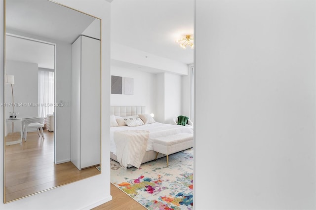 bedroom featuring hardwood / wood-style flooring and multiple windows