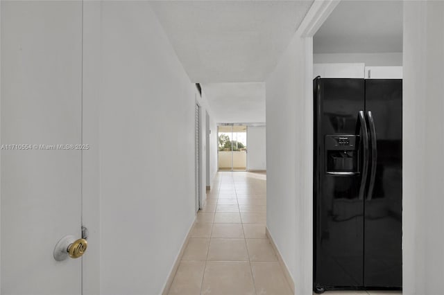 hall with light tile patterned floors