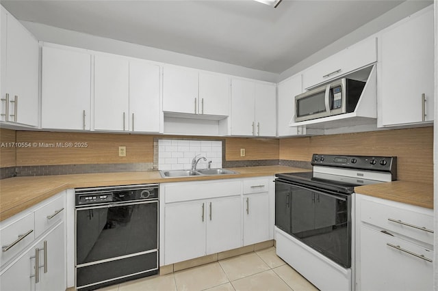 kitchen featuring sink, light tile patterned floors, white range with electric cooktop, black dishwasher, and white cabinetry