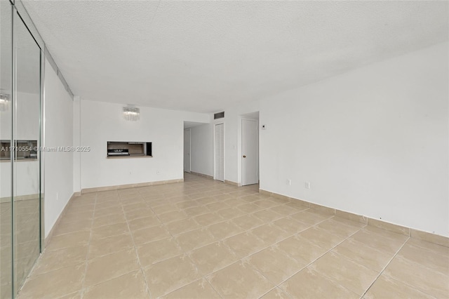 unfurnished living room featuring a fireplace and a textured ceiling