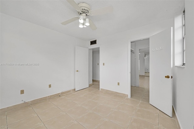 unfurnished bedroom featuring ceiling fan and light tile patterned flooring