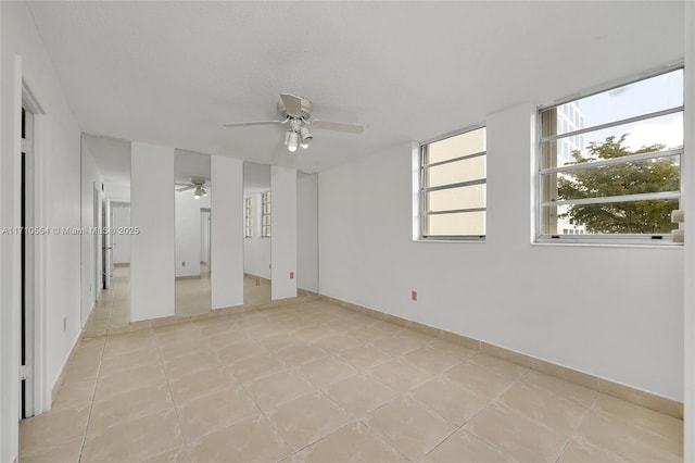 unfurnished room featuring ceiling fan and a textured ceiling