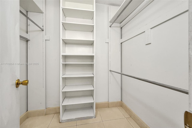 walk in closet featuring light tile patterned floors