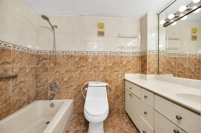 full bathroom with tiled shower / bath, vanity, tile walls, and toilet