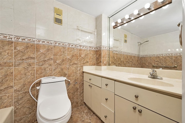 bathroom featuring vanity, toilet, and tile walls