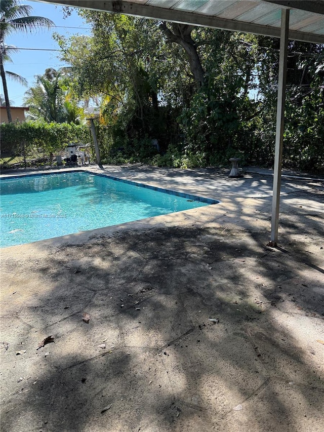 view of swimming pool with a patio