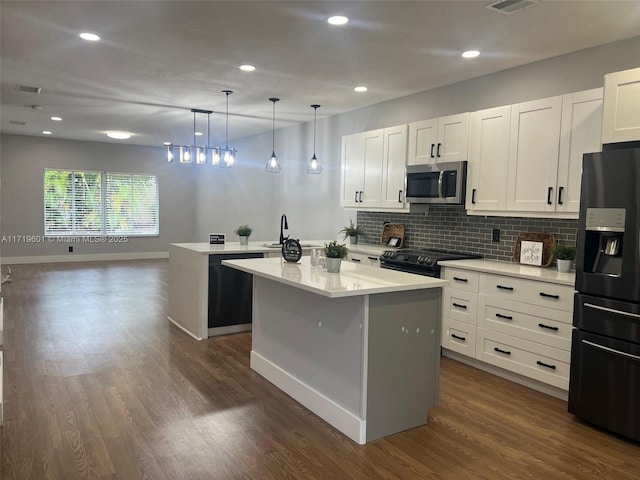 kitchen with pendant lighting, white cabinetry, a kitchen island, and black appliances