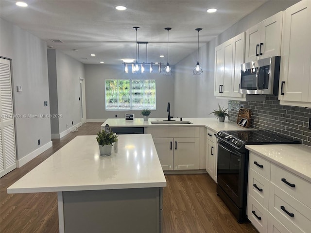 kitchen with backsplash, white cabinetry, sink, and black electric range