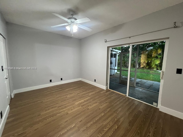 spare room featuring ceiling fan and dark hardwood / wood-style flooring