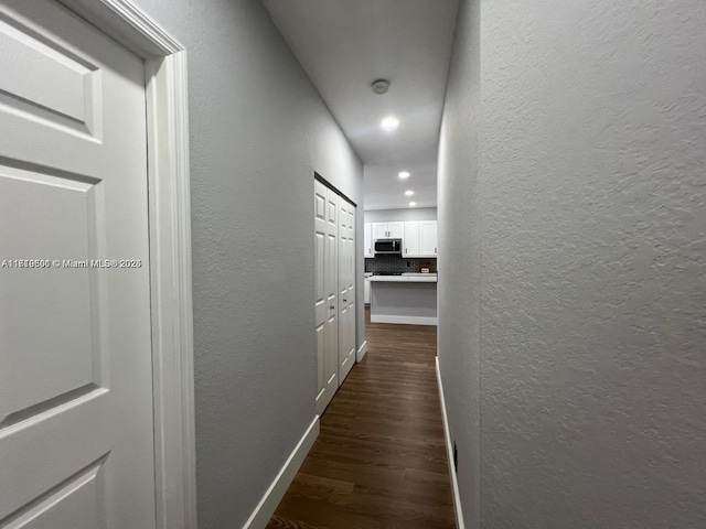 hall with dark hardwood / wood-style floors