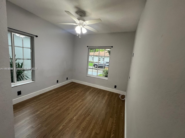 unfurnished room featuring dark hardwood / wood-style flooring and ceiling fan