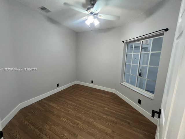 spare room with dark hardwood / wood-style flooring and ceiling fan