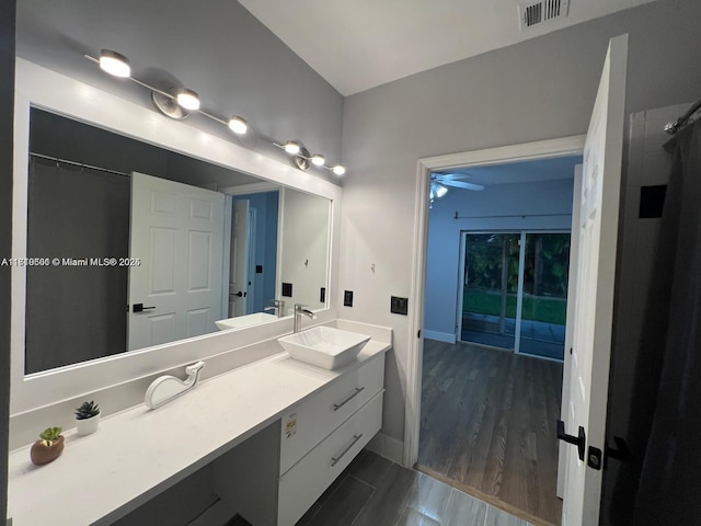 bathroom with curtained shower, ceiling fan, vanity, and hardwood / wood-style flooring