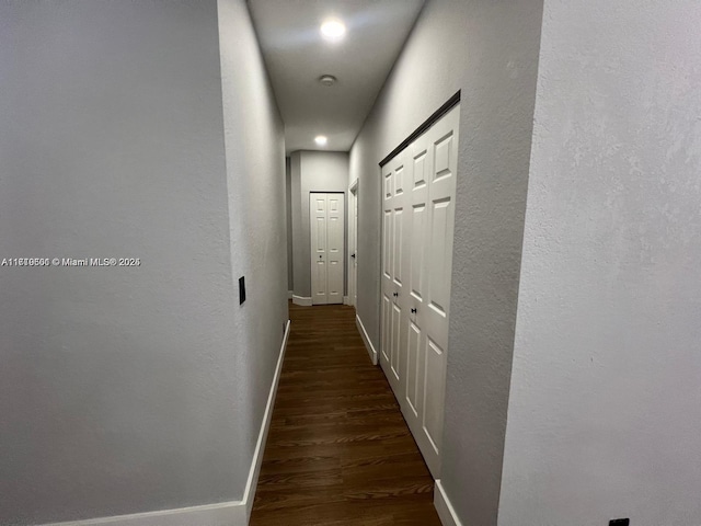 hall with dark hardwood / wood-style floors