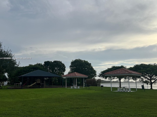 view of home's community featuring a gazebo, a water view, and a yard