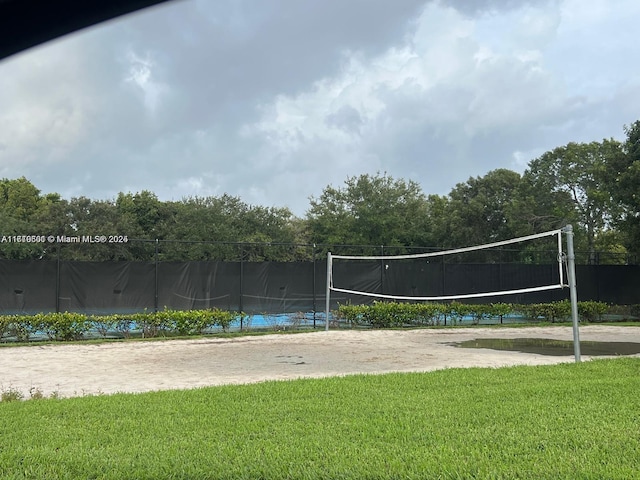 surrounding community featuring a yard and volleyball court