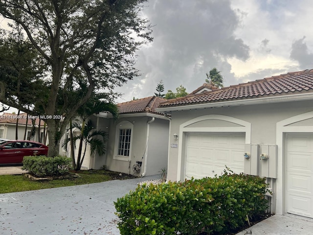 mediterranean / spanish-style home featuring a garage