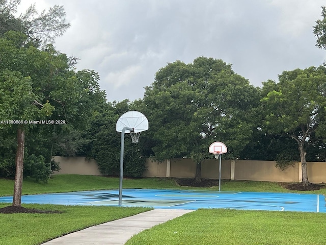 view of basketball court featuring a lawn