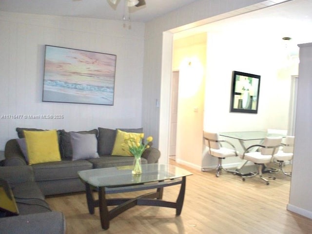 living room with ceiling fan and wood-type flooring