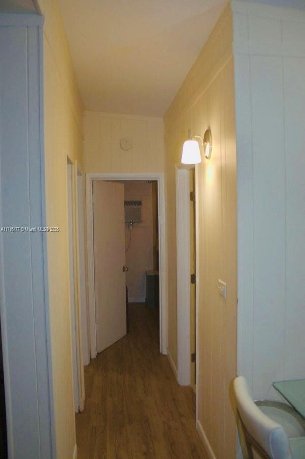 corridor with hardwood / wood-style floors