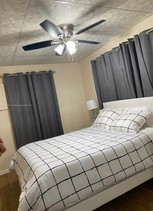 bedroom featuring hardwood / wood-style flooring and ceiling fan