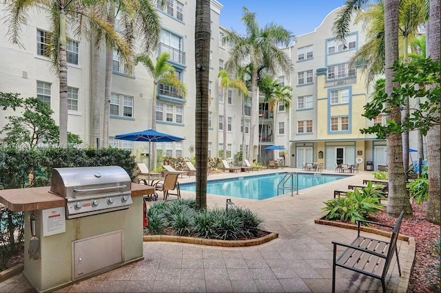 view of swimming pool with a grill and a patio area