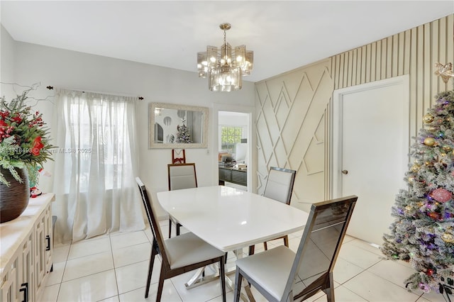 tiled dining space with a healthy amount of sunlight and a chandelier