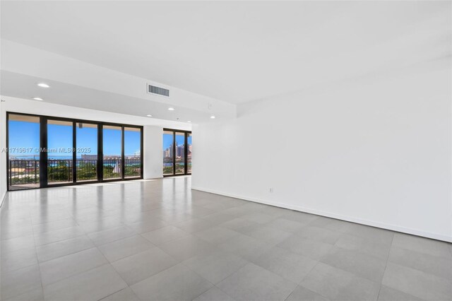 empty room featuring a wall of windows