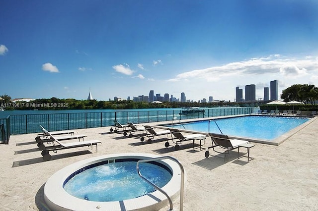 view of pool featuring a community hot tub and a patio